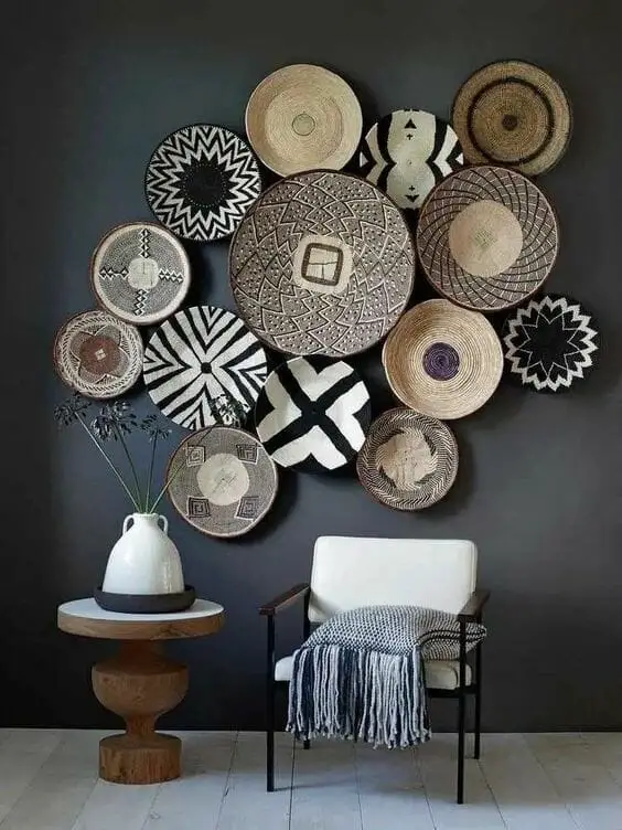 Photo of woven baskets hang up on the wall.