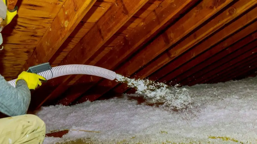 Photo of a person laying down spray foam insulation.