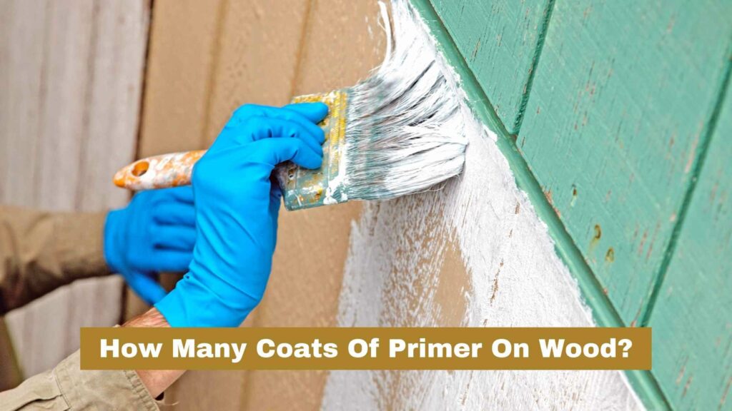Photo of a person applying a coat of primer on a wood wall. How Many Coats Of Primer On Wood?