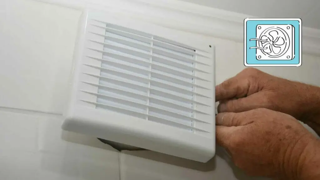 Photo of a person mounting a fan on a bathroom. How to Vent a Bathroom with No Outside Access?