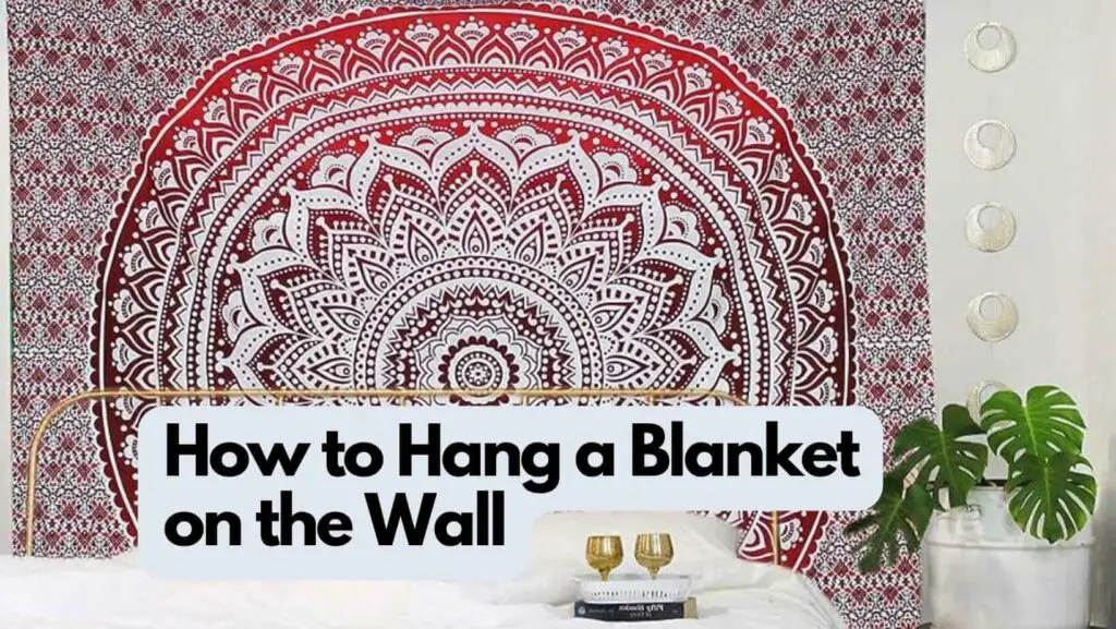 Photo of a blanket hanging on the wall from behind a bed. How to Hang a Blanket on the Wall.
